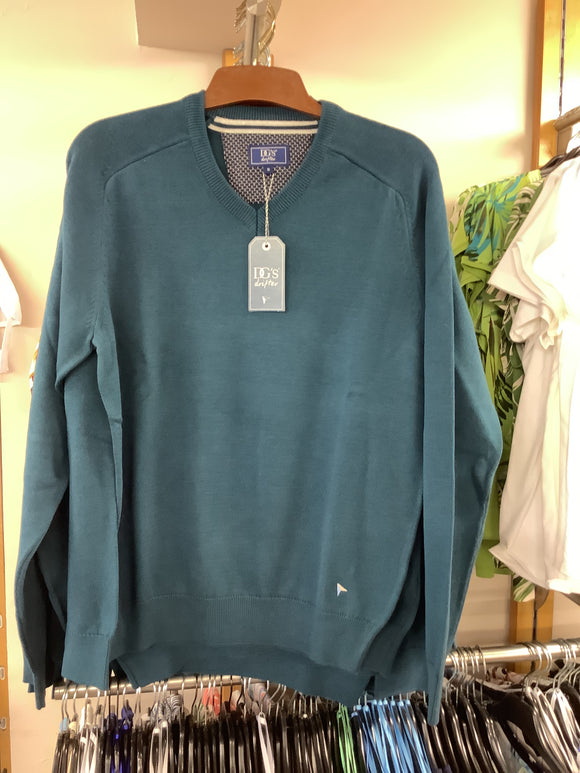 Teal sweatshirt on a mannequin with a tag in a store setting