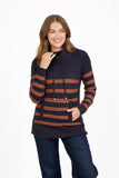 A woman modeling a MUDFLOWER navy blue and rust brown horizontally striped knit cowl neck sweater with drawstrings and front pockets, paired with dark blue jeans, against a plain white background.