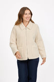 A woman wearing a MUDFLOWER ivory sherpa fleece zip-up jacket with a wide collar and front pockets, paired with dark blue jeans, against a plain white studio background. Available to buy from mooreheads.co.uk 